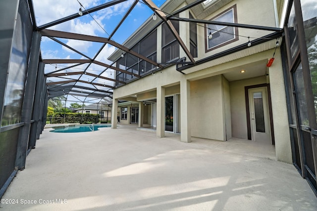 view of patio featuring a lanai