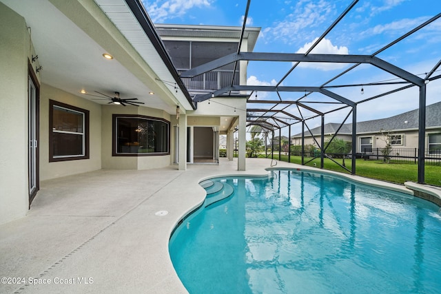 view of pool with a lanai, a patio area, and ceiling fan