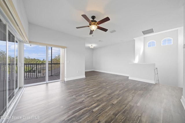 unfurnished living room with ceiling fan and dark hardwood / wood-style flooring