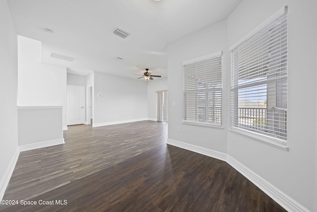 empty room featuring ceiling fan and dark wood-type flooring