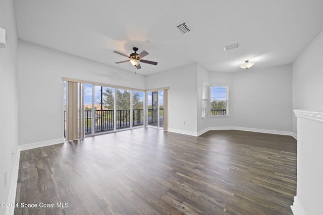 empty room featuring ceiling fan and dark hardwood / wood-style flooring