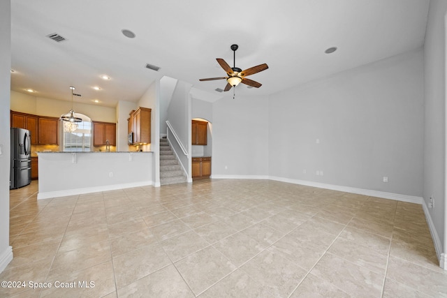 unfurnished living room with ceiling fan, sink, and light tile patterned flooring