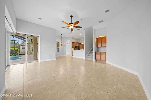 unfurnished living room with ceiling fan and light tile patterned flooring