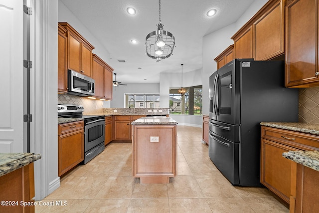 kitchen featuring a center island, tasteful backsplash, decorative light fixtures, kitchen peninsula, and stainless steel appliances