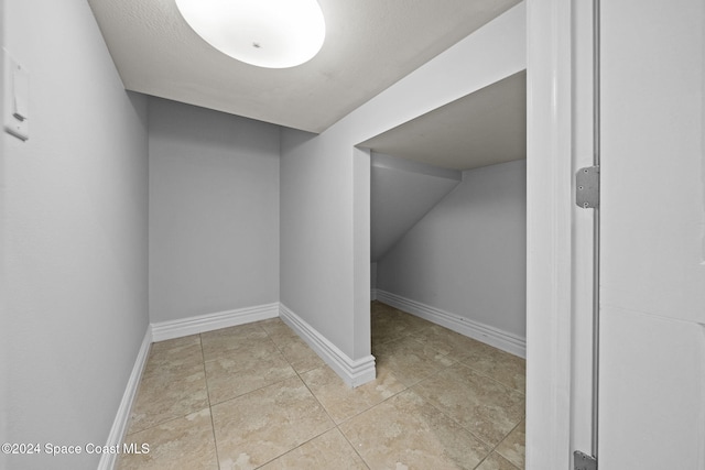 bonus room featuring light tile patterned flooring