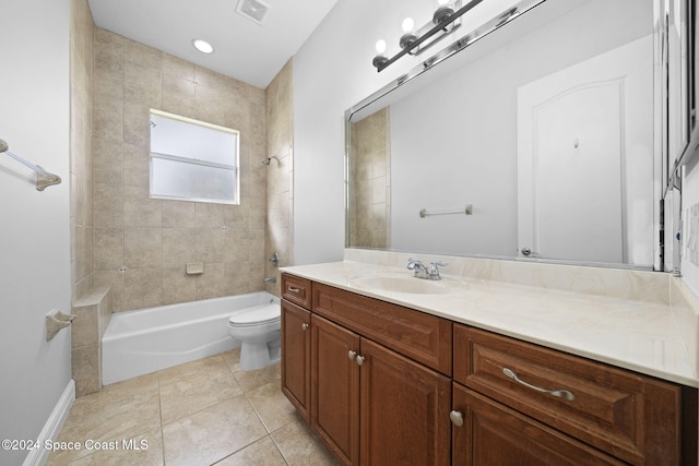 full bathroom with tile patterned flooring, vanity, toilet, and tiled shower / bath combo