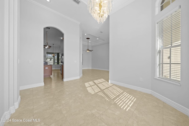 empty room with crown molding, light tile patterned flooring, and ceiling fan with notable chandelier