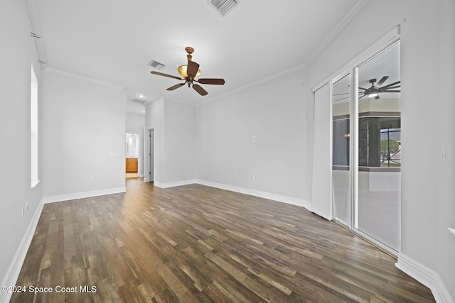 unfurnished living room with ceiling fan, ornamental molding, and dark wood-type flooring