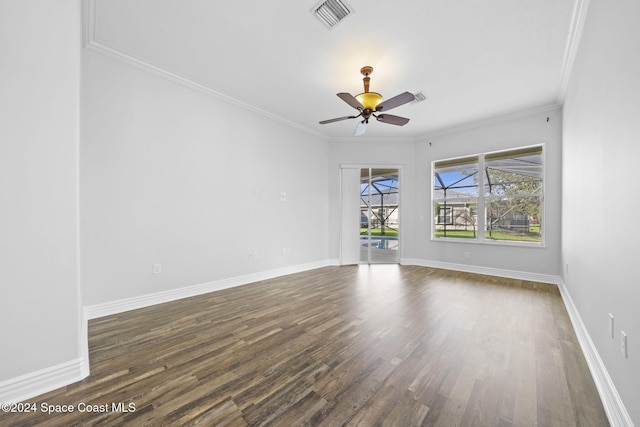 spare room with dark hardwood / wood-style floors, ceiling fan, and ornamental molding