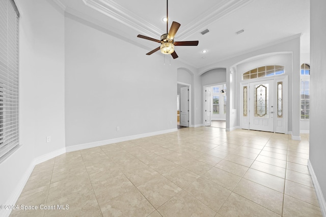 tiled foyer entrance featuring ceiling fan and crown molding