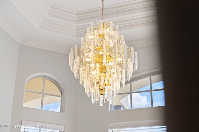 details with an inviting chandelier and ornamental molding