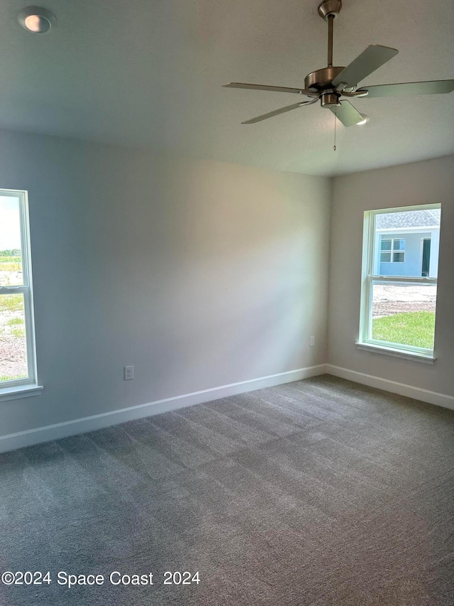 empty room with carpet flooring and ceiling fan