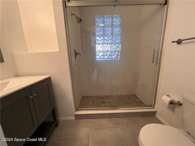 bathroom featuring vanity, toilet, and walk in shower