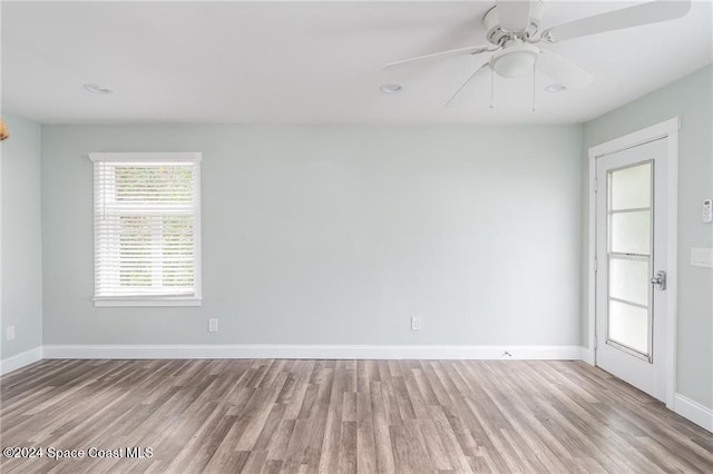 spare room featuring ceiling fan and light hardwood / wood-style flooring