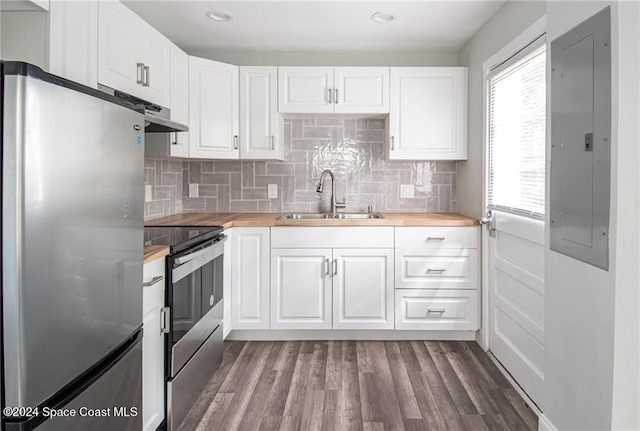 kitchen with white cabinetry, stainless steel appliances, sink, and wooden counters