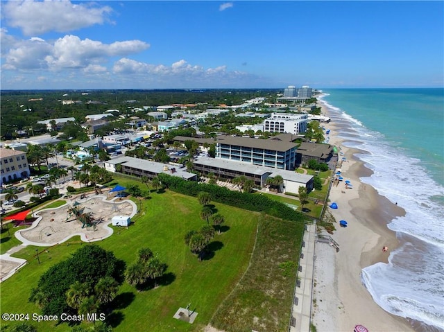 bird's eye view featuring a water view and a beach view