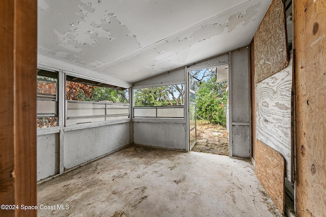 unfurnished sunroom with lofted ceiling