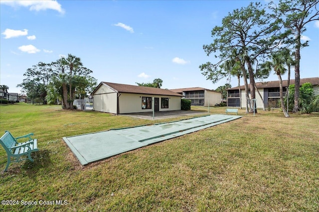 rear view of property with a lawn