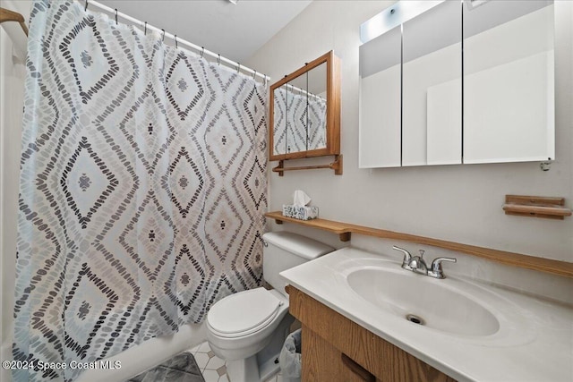 bathroom with tile patterned floors, vanity, and toilet