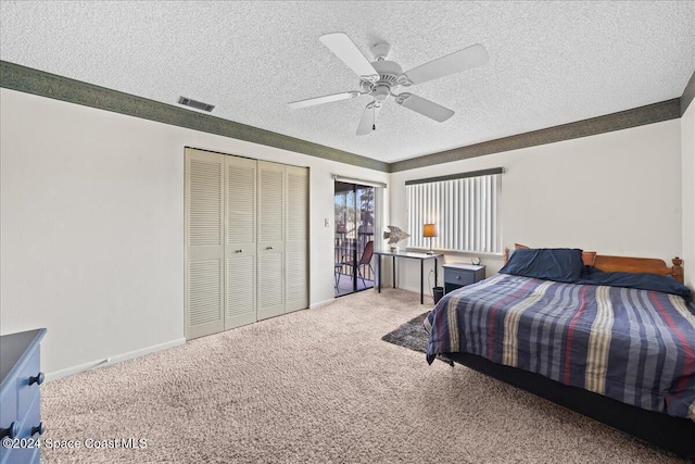 carpeted bedroom with ceiling fan, a textured ceiling, and a closet