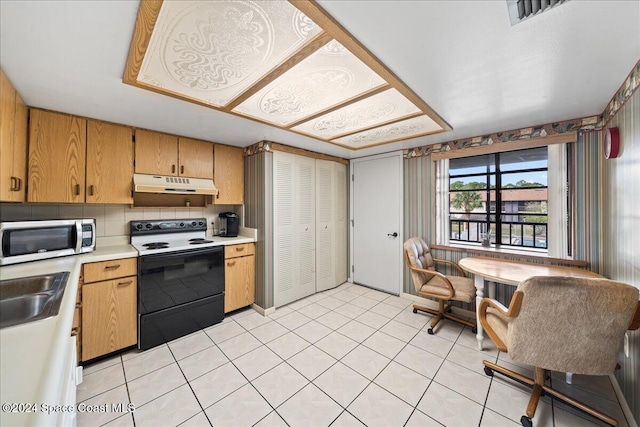 kitchen featuring tasteful backsplash, sink, light tile patterned flooring, and white electric range