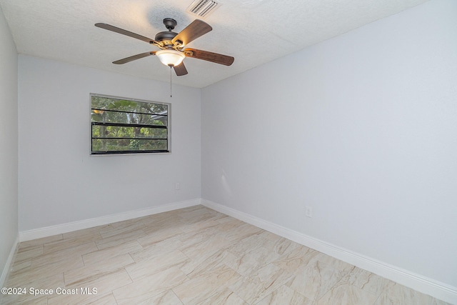 empty room featuring ceiling fan and a textured ceiling