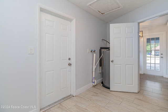 interior space featuring water heater and washer hookup