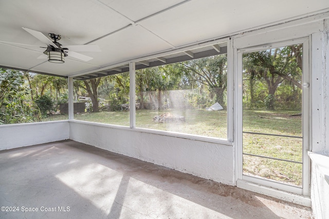 unfurnished sunroom with ceiling fan