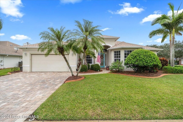 view of front of home featuring a garage and a front yard