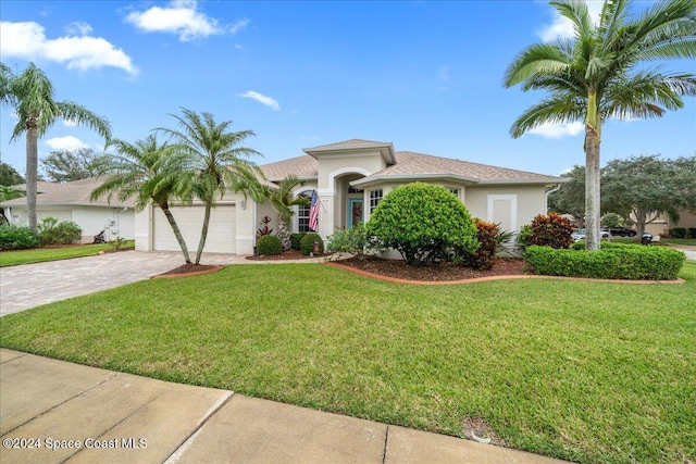 view of front of house with a garage and a front yard