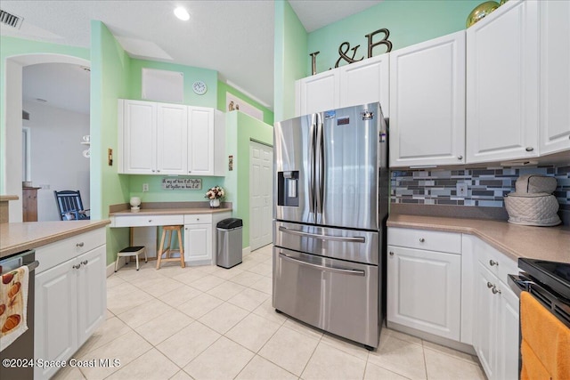 kitchen featuring white cabinets, light tile patterned flooring, and stainless steel appliances