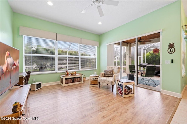 sunroom featuring ceiling fan and plenty of natural light