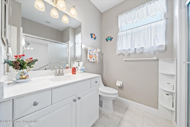 bathroom featuring walk in shower, vanity, tile patterned floors, and toilet