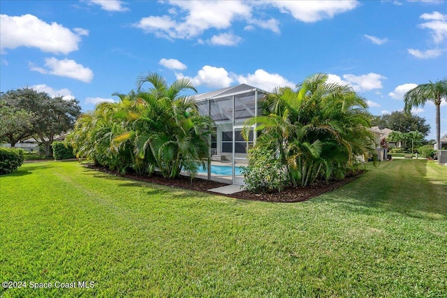 view of yard with glass enclosure