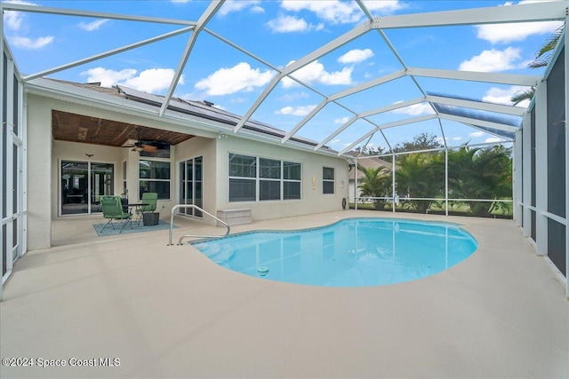 view of swimming pool with a patio area, a lanai, and ceiling fan