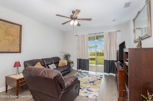 living room with hardwood / wood-style flooring and ceiling fan