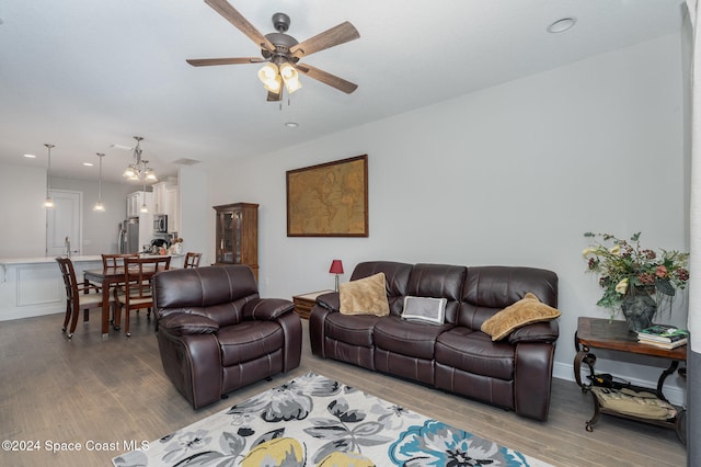 living room with hardwood / wood-style flooring and ceiling fan