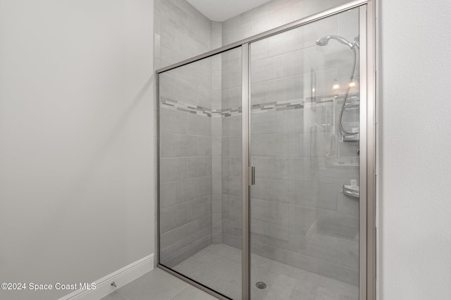 bathroom with tile patterned flooring and an enclosed shower