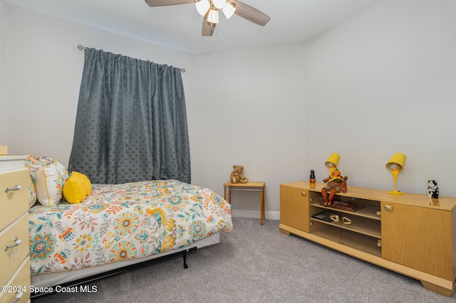 bedroom featuring ceiling fan and carpet