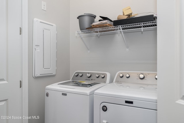 washroom featuring electric panel and washing machine and dryer