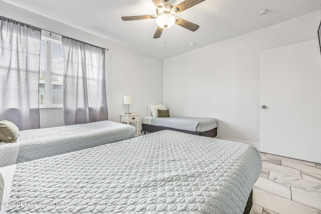 3524 S Atlantic Ave, Cocoa Beach, FL 32931 - bedroom with light marble finish floors and a ceiling fan