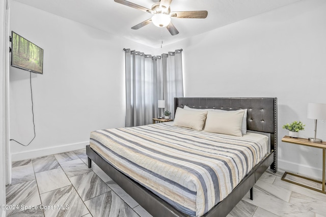 3524 S Atlantic Ave, Cocoa Beach, FL 32931 - bedroom featuring light marble finish floors, baseboards, and ceiling fan