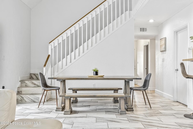 3524 S Atlantic Ave, Cocoa Beach, FL 32931 - dining area featuring stairway and baseboards