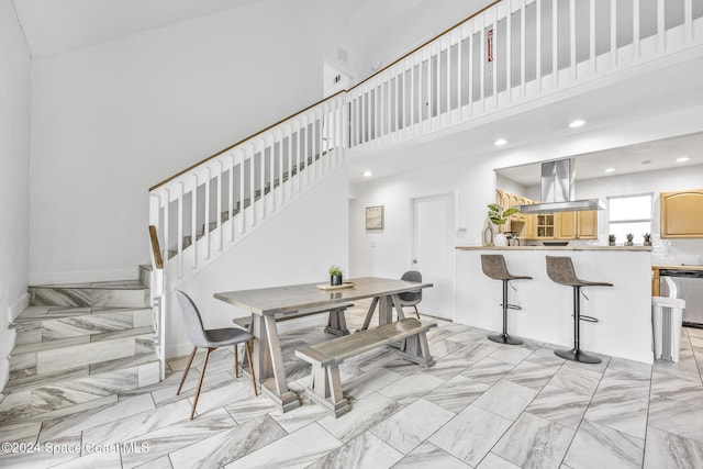 3524 S Atlantic Ave, Cocoa Beach, FL 32931 - dining space with a high ceiling, stairs, and recessed lighting