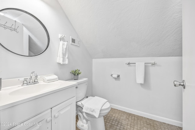 3524 S Atlantic Ave, Cocoa Beach, FL 32931 - bathroom with a textured ceiling, lofted ceiling, toilet, vanity, and baseboards