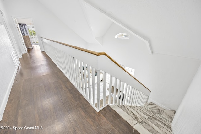 3524 S Atlantic Ave, Cocoa Beach, FL 32931 - stairway featuring lofted ceiling, wood finished floors, and baseboards