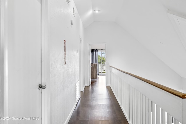 3524 S Atlantic Ave, Cocoa Beach, FL 32931 - hallway featuring vaulted ceiling, dark wood-style floors, and baseboards