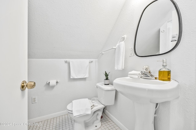 3524 S Atlantic Ave, Cocoa Beach, FL 32931 - half bathroom featuring lofted ceiling, baseboards, and toilet
