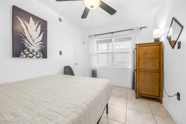 3524 S Atlantic Ave, Cocoa Beach, FL 32931 - bedroom featuring light marble finish floors, baseboards, and ceiling fan