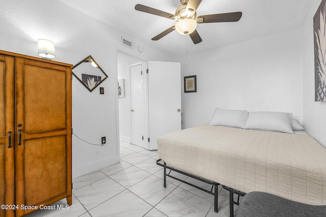3524 S Atlantic Ave, Cocoa Beach, FL 32931 - bedroom featuring light marble finish flooring and a textured ceiling